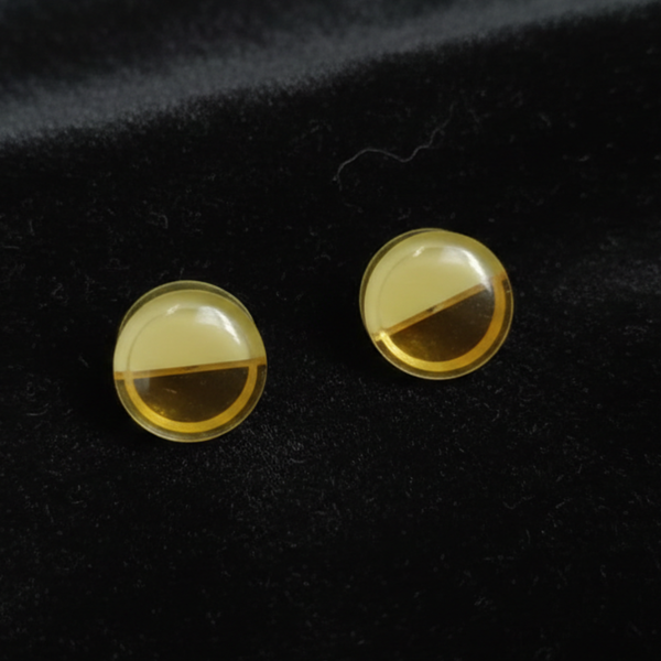 Jwanas Amber Glow Dual-Tone Oval Stud Earrings flat lay on black background