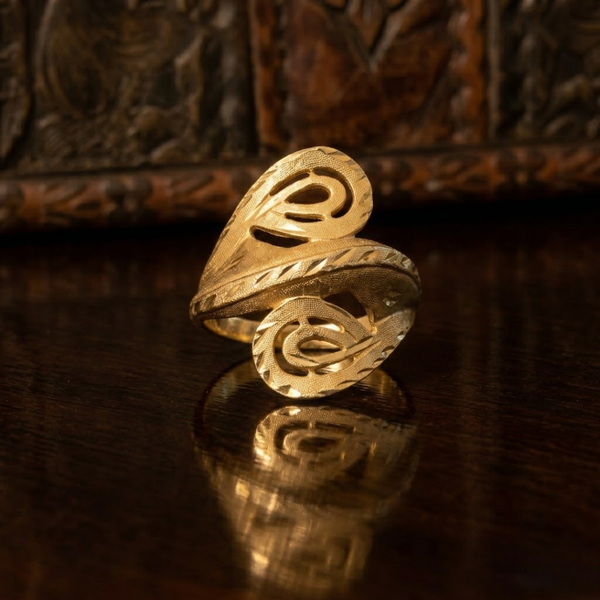 Jwanas Astra Filigree Bypass Ring close-up on dark reflective surface