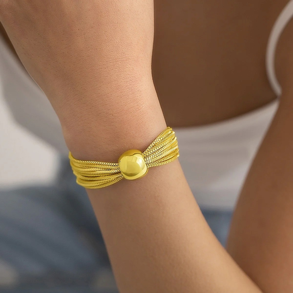 Close-up of Jwanas Aurelia Multi-Strand Orb Bracelet worn on wrist
