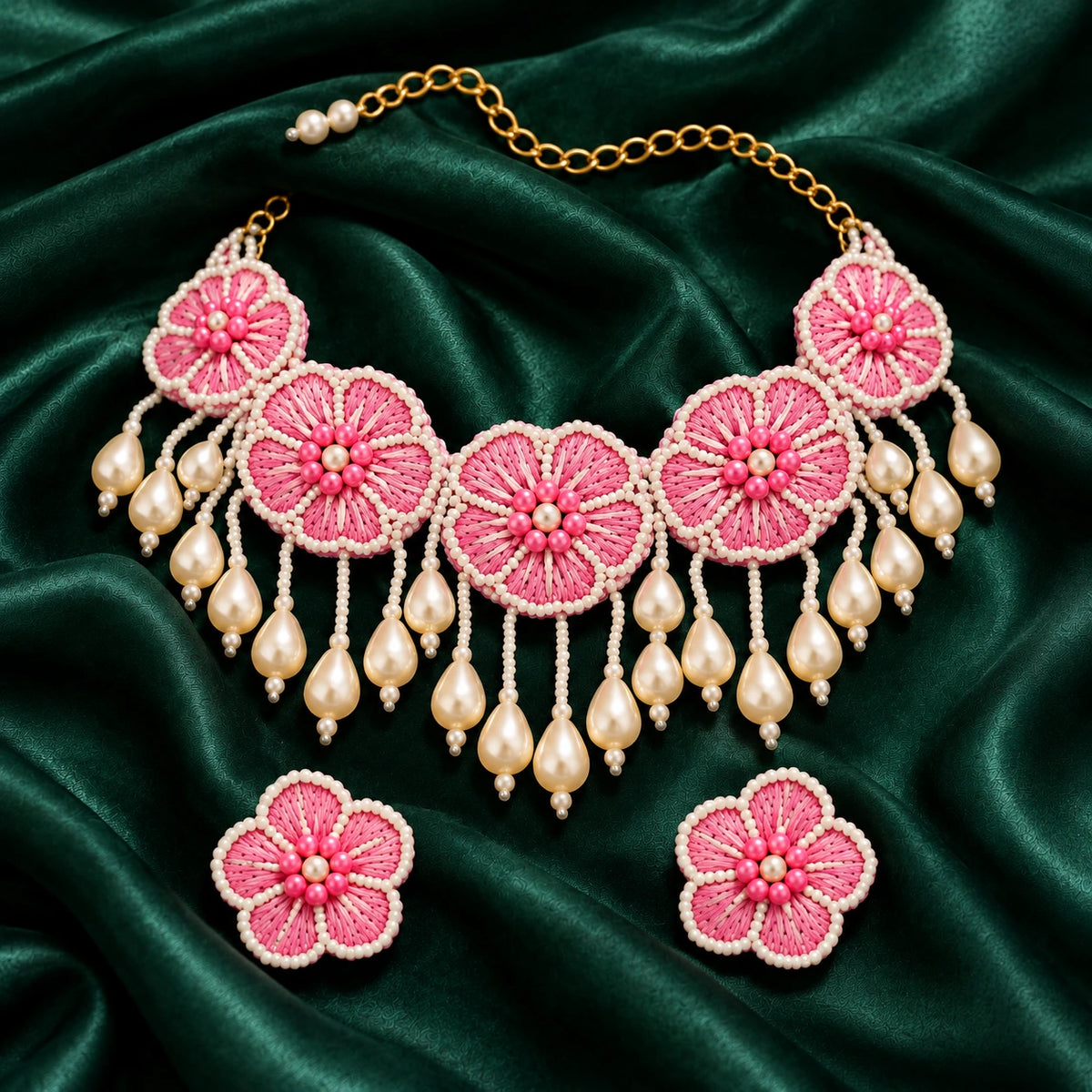 Jwanas Camellia Bloom Handmade Necklace Set flat lay on green satin