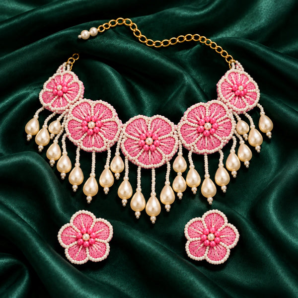 Jwanas Camellia Bloom Handmade Necklace Set flat lay on green satin