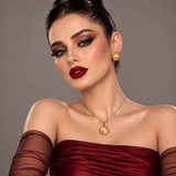 Model wearing Jwanas Celestia Pearl-Style Sunburst pendant and earrings