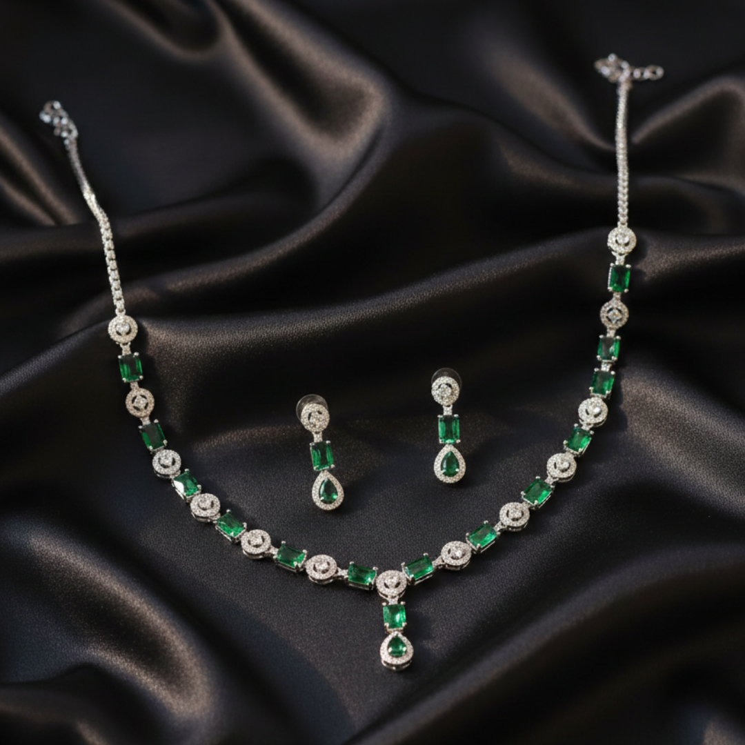Emerald Queen necklace and drop earrings set on black fabric.