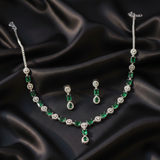 Emerald Queen necklace and drop earrings set on black fabric.