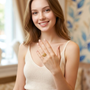 Model wearing the Jwanas Ethereal Wave Filigree Ring, smiling with hand raised near shoulder