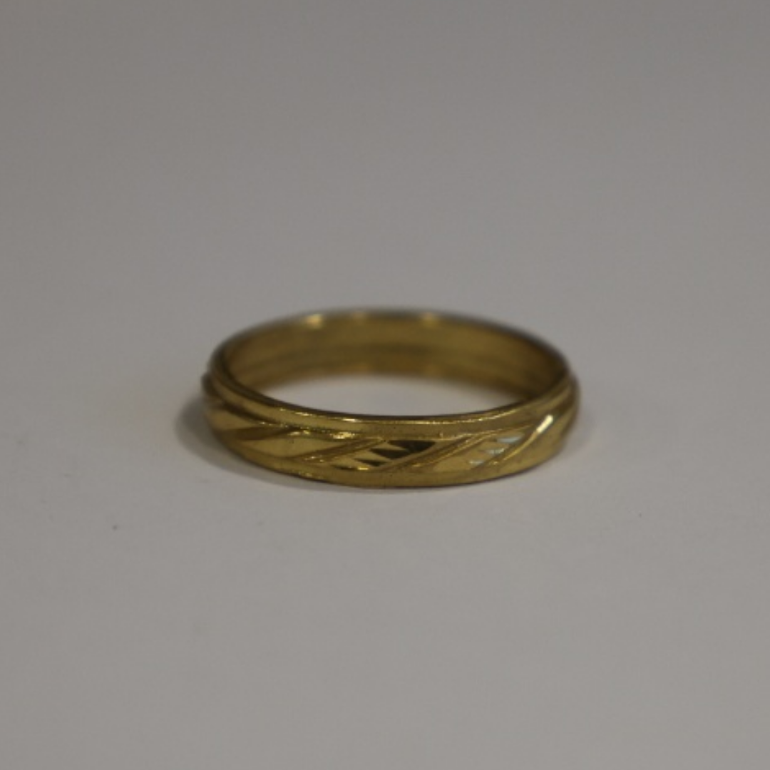Jwanas Gilded Swirl Cocktail Ring close-up on grey background