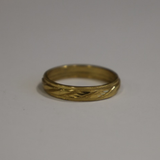 Jwanas Gilded Swirl Cocktail Ring close-up on grey background