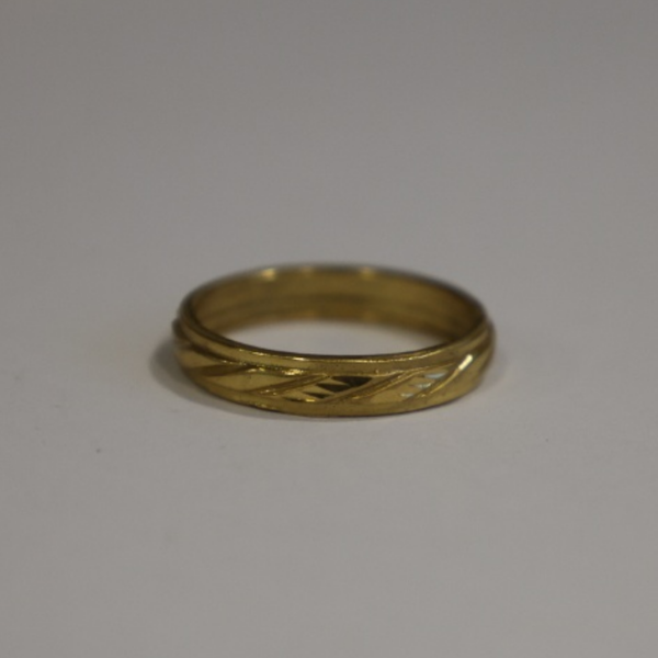 Jwanas Gilded Swirl Cocktail Ring close-up on grey background