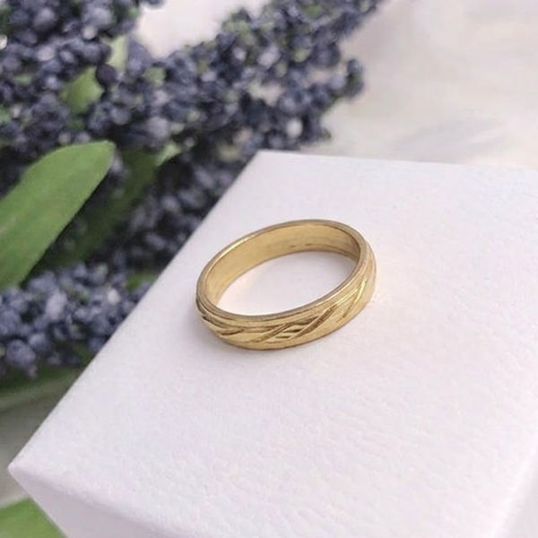 Jwanas Gilded Swirl Cocktail Ring flat lay on white box