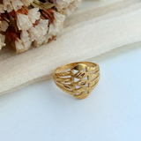 Jwanas Gilded Swirl Filigree Ring flat lay on light fabric