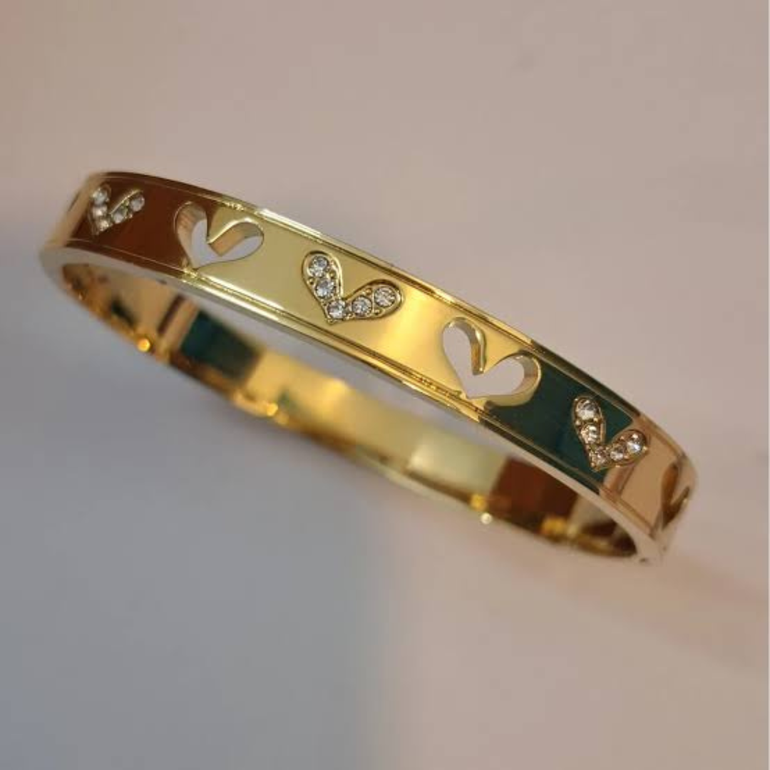 Close-up of Jwanas Gold Heart Charm Bangle Bracelet