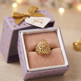 Jwanas Golden Pinwheel Filigree Ring displayed in jewellery box packaging
