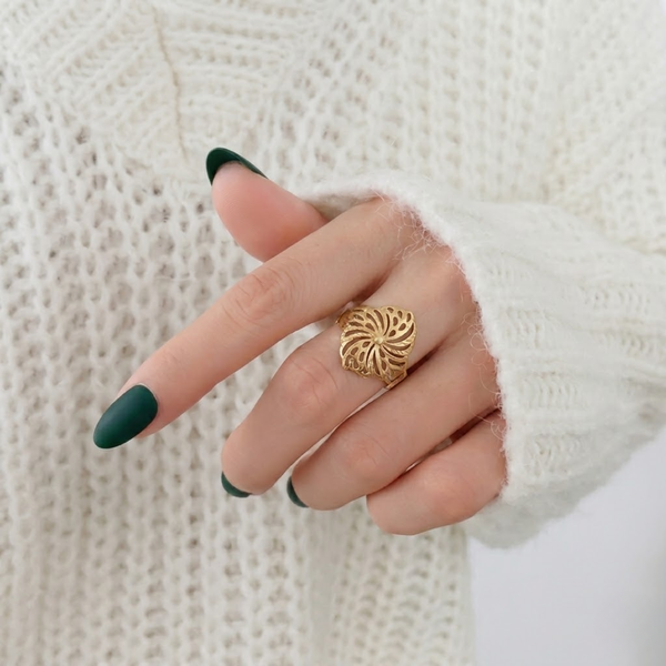 Close-up of Jwanas Golden Pinwheel Filigree Ring worn on hand