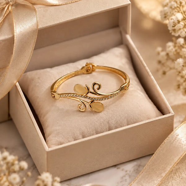 Jwanas Golden Vine Leaf Bangle displayed in gift box packaging