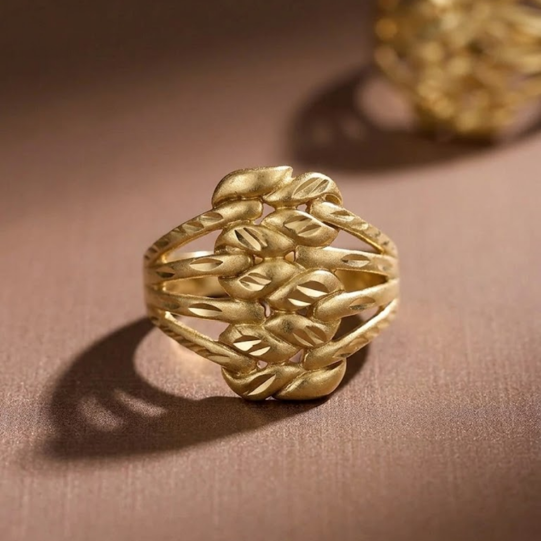 Jwanas Harvest Grain Textured Ring worn on pink background, close-up