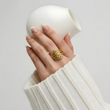 Close-up of Jwanas Harvest Grain Textured Ring worn on hand