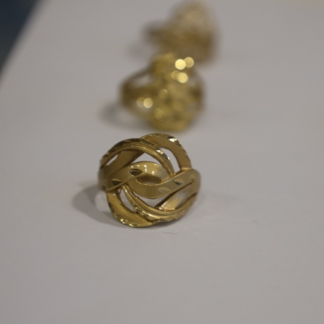 Jwanas Infinite Knot Sculptural Ring close-up on grey background