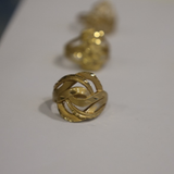 Jwanas Infinite Knot Sculptural Ring close-up on grey background