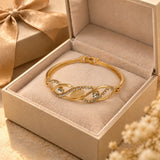 Jwanas Infinity Wave Crystal Bangle displayed in gift box packaging