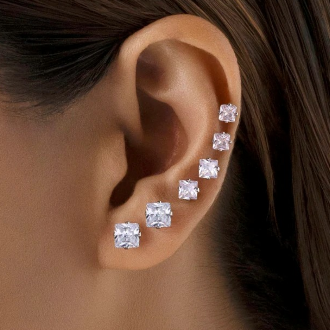 Close-up of Jwanas Lucent Princess-Cut Studs worn on ear