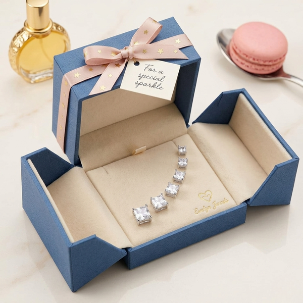 Jwanas Lucent Princess-Cut Studs displayed in gift box packaging