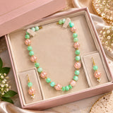 Jwanas Meadow Jade & Blossom Beaded Necklace Set displayed inside an open pink jewellery box with matching earrings