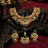 Jwanas Meera Royal necklace and matching earrings displayed as a flat lay on dark fabric