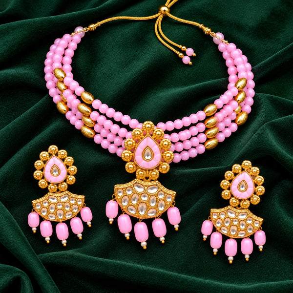 Jwanas Pink Blossom Beaded Choker Set displayed as a flat lay on dark green velvet with matching earrings