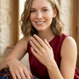 Model wearing the Jwanas Radiant Solar Mandala Ring, smiling with hand forward
