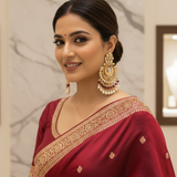 Model wearing Kundan Meenakari Chandbali Earrings with maroon saree