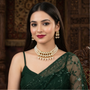 Model wearing Royal Pearl and Kundan necklace set with earrings.