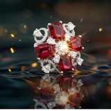 Close-up of Jwanas Ruby-Red Floral Cocktail Ring with reflective water styling