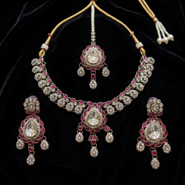 Jwanas Ruby-Toned Crystal jewellery set flat lay on fabric