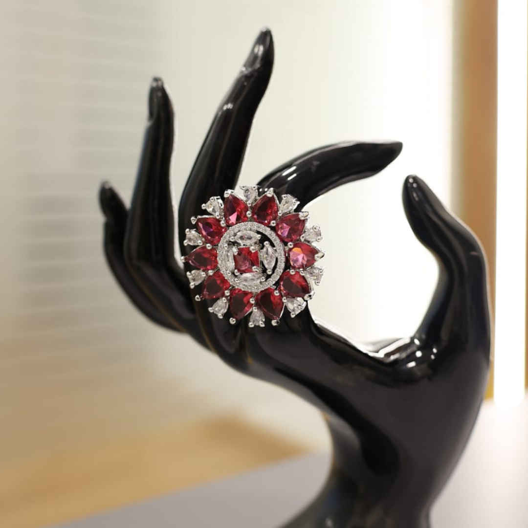 Jwanas Ruby-radiance Sunburst Cocktail Ring worn on hand, close-up