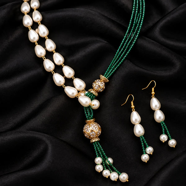 Jwanas Verdant Pearl Cascade Necklace Set displayed as a flat lay on black satin fabric with matching earrings