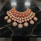 Jwanas Zeenat Ruby-Toned Bridal Choker flat lay on a black marble surface