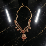Jwanas Rani Haar (long necklace) from the Zeenat Ruby-Toned Bridal Choker Set on a black marble surface
